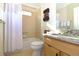 Bathroom with a bathtub, granite countertops, wood cabinets, and tile flooring at 287 Ellenton Run, The Villages, FL 32162