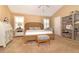 Comfortable bedroom features a woven bed frame, neutral paint, and white plantation shutters at 287 Ellenton Run, The Villages, FL 32162