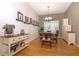 Cozy dining room featuring hardwood floors, stylish decor, and natural light, perfect for Gathering meals at 287 Ellenton Run, The Villages, FL 32162
