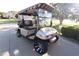 Street legal golf cart with custom wheels and windshield, ready for leisurely rides around the neighborhood at 287 Ellenton Run, The Villages, FL 32162
