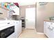 Bright laundry room with a modern white washer and dryer, ample storage, and a clean, organized space at 287 Ellenton Run, The Villages, FL 32162