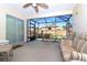 Spacious screened-in patio with a ceiling fan and cushioned seating at 287 Ellenton Run, The Villages, FL 32162
