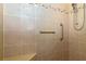 Walk-in shower with tiled walls, a corner seat, and a hand-held shower head at 287 Ellenton Run, The Villages, FL 32162