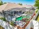 Elevated view of backyard with a screened pool, spa, rock waterfall, and lush landscaping at 2894 Southern Pines Loop, Clermont, FL 34711