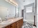 Bathroom featuring double sink vanity, shower with tub, toilet and patterned rug at 2894 Southern Pines Loop, Clermont, FL 34711