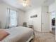 Bedroom with carpet, cozy window and light gray bedding with ceiling fan at 2894 Southern Pines Loop, Clermont, FL 34711