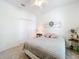 Cozy bedroom featuring a neutral color palette, closet, and a charming decorative wreath above the bed at 2894 Southern Pines Loop, Clermont, FL 34711