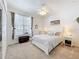 Cozy bedroom featuring carpet, a large window, and a comfortable bed with decorative pillows at 2894 Southern Pines Loop, Clermont, FL 34711
