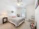 Bright bedroom featuring neutral tones, a ceiling fan, and natural light from the window at 2894 Southern Pines Loop, Clermont, FL 34711