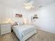 Comfortable bedroom with white furniture, neutral bedding, ceiling fan and carpeted floors at 2894 Southern Pines Loop, Clermont, FL 34711