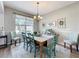 Inviting dining room with elegant decor, chandelier, and natural light, perfect for gatherings at 2894 Southern Pines Loop, Clermont, FL 34711