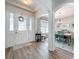 Bright foyer showcasing wood flooring and open access to the dining room at 2894 Southern Pines Loop, Clermont, FL 34711