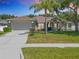Charming single-story home with a well-manicured lawn, mature landscaping, and an attached two-car garage at 2894 Southern Pines Loop, Clermont, FL 34711