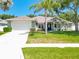 Charming single-story home featuring a well-manicured lawn and inviting curb appeal on a sunny day at 2894 Southern Pines Loop, Clermont, FL 34711