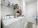 Laundry room featuring modern washer and dryer with ample storage shelves at 2894 Southern Pines Loop, Clermont, FL 34711