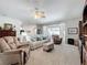 Spacious living room featuring comfortable seating and a ceiling fan for added comfort at 2894 Southern Pines Loop, Clermont, FL 34711