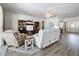Living room featuring wood flooring, neutral colors, and a seamless flow into other living spaces at 2894 Southern Pines Loop, Clermont, FL 34711
