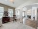Bright and airy living room with wood floors and views into the dining area at 2894 Southern Pines Loop, Clermont, FL 34711