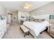 Inviting main bedroom with a white bed, bench seating, a ceiling fan, and ample closet space at 2894 Southern Pines Loop, Clermont, FL 34711