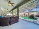 View of covered patio with comfortable seating area and a pool at 2894 Southern Pines Loop, Clermont, FL 34711