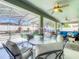 Screened-in patio with ceiling fans, outdoor seating, and views of the pool and fenced yard at 2894 Southern Pines Loop, Clermont, FL 34711