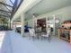 Outdoor patio with seating and dining area overlooking the landscaped yard and pool at 2894 Southern Pines Loop, Clermont, FL 34711