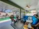 Screened-in patio with a wicker seating area and view of the pool at 2894 Southern Pines Loop, Clermont, FL 34711