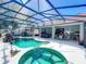 Screened-in pool and spa with multiple seating areas and lush landscaping at 2894 Southern Pines Loop, Clermont, FL 34711
