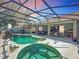 Relaxing screened-in pool and patio with a water feature and outdoor dining area, perfect for entertaining at 2894 Southern Pines Loop, Clermont, FL 34711