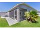 Exterior view of the screened lanai and patio, opening to a fenced-in yard at 2919 Gulley Ln, The Villages, FL 32163