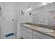 Bathroom with a double vanity, framed mirror, and walk-in shower at 2919 Gulley Ln, The Villages, FL 32163