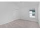 Neutral bedroom with carpet, closet, and large window allowing natural light at 2919 Gulley Ln, The Villages, FL 32163