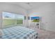 Bright bedroom with a window, ceiling fan, and a white storage shelf at 2919 Gulley Ln, The Villages, FL 32163