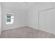 Neutral bedroom with carpet, closet, and large window allowing natural light at 2919 Gulley Ln, The Villages, FL 32163