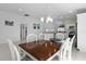 Dining area featuring a stylish chandelier, modern decor, and an open view to the kitchen at 2919 Gulley Ln, The Villages, FL 32163
