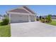 Wide driveway leading to a three-car garage, providing ample parking space at 2919 Gulley Ln, The Villages, FL 32163