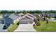 Home exterior with well-kept lawn, landscaping, and paved driveway on a sunny day at 2919 Gulley Ln, The Villages, FL 32163