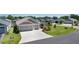 Exterior view of the home with driveway and manicured lawn in a sidewalk neighborhood at 2919 Gulley Ln, The Villages, FL 32163