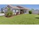 Charming home featuring a well-manicured lawn and nicely landscaped front yard at 2919 Gulley Ln, The Villages, FL 32163