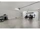 Spacious garage with golf cart, storage, and clean epoxy flooring at 2919 Gulley Ln, The Villages, FL 32163