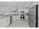 Bright kitchen featuring white cabinets, stainless steel appliances, and tile flooring at 2919 Gulley Ln, The Villages, FL 32163
