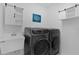 Convenient laundry room featuring modern washer and dryer and farmhouse-style decor at 2919 Gulley Ln, The Villages, FL 32163