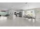 Spacious open-concept living area with tile floors, modern kitchen, and dining area at 2919 Gulley Ln, The Villages, FL 32163
