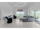 Open living room with tile flooring, comfortable seating, and sliding glass doors to the outside at 2919 Gulley Ln, The Villages, FL 32163