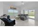 Bright living room featuring tile floors, comfortable seating, and sliding glass doors to the outside at 2919 Gulley Ln, The Villages, FL 32163