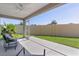Screened patio with ceiling fan overlooking green lawn and mature landscaping at 2919 Gulley Ln, The Villages, FL 32163