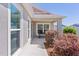 Inviting front porch with decorative shrubs and a cozy seating area at 2919 Gulley Ln, The Villages, FL 32163