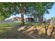 Expansive backyard featuring a mature tree and a view of the home's exterior and pergola at 30236 Pga Dr, Sorrento, FL 32776