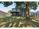 A spacious backyard featuring mature trees, manicured lawn and a view of the home's exterior at 30236 Pga Dr, Sorrento, FL 32776