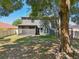Expansive backyard with screened porch, swing set and mature trees offering ample shade at 30236 Pga Dr, Sorrento, FL 32776